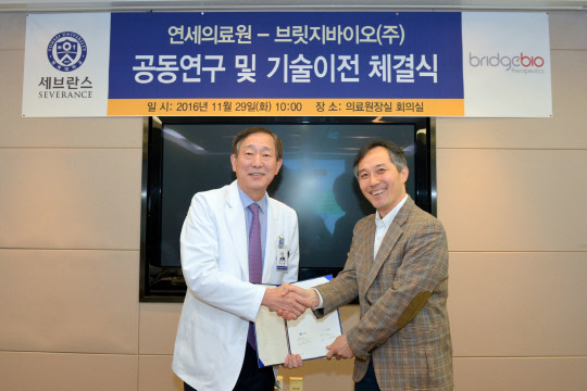 29일 연세의료원 교수회의실에서 윤도흠 연세의료원장(왼쪽)과 이정규 브릿지바이오 대표이사가 호흡기 염증성 질환 치료용 혁신 신약 개발에 대한 공동 연구 및 기술 이전 계약을 체결하고 기념촬영을 하고 있다.(연세의료원 제공)